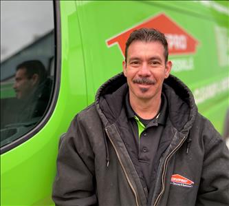 Male SERVPRO of Charlottesville standing next to our service van.