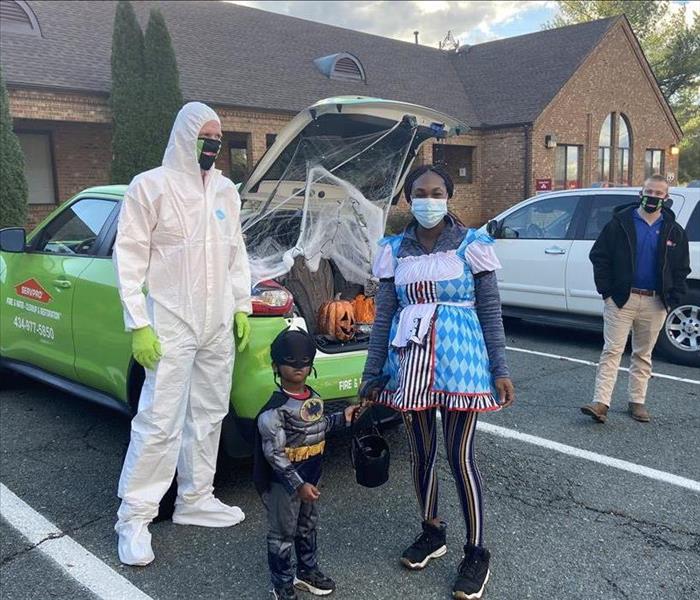 SERVPRO employees with Trunk or Treaters next to our decorated Juke trunk.