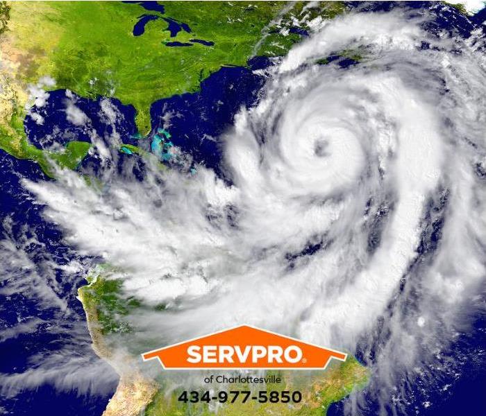 A satellite view of an enormous hurricane over the Atlantic Ocean is shown.