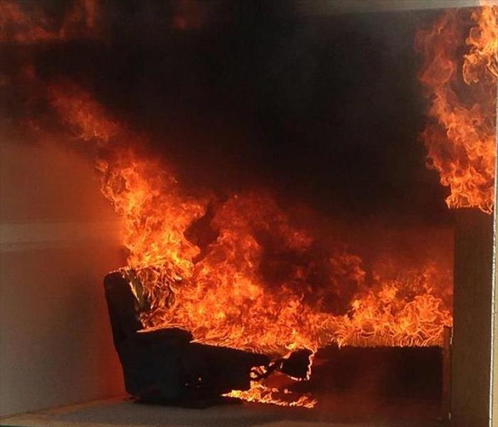 Dramatic fire engulfed couch.