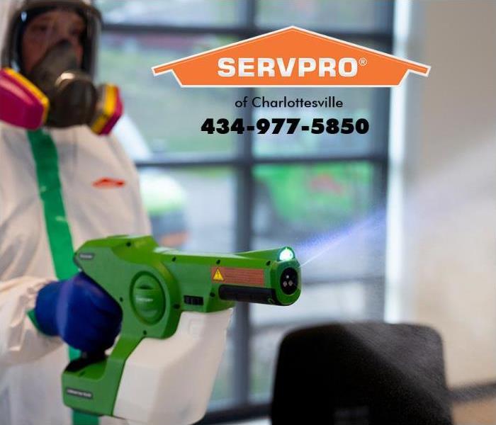 A SERVPRO professional is shown decontaminating an office. 